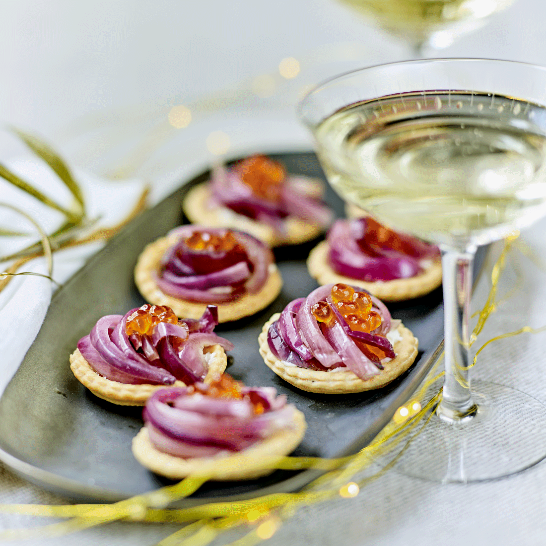 Tartlets with candied onions and salmon eggs